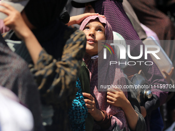 Displaced Palestinians are gathering to receive food at a donation point in Deir al-Balah, central Gaza Strip, on April 19, 2024, amid ongoi...