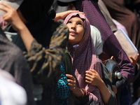 Displaced Palestinians are gathering to receive food at a donation point in Deir al-Balah, central Gaza Strip, on April 19, 2024, amid ongoi...