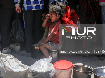 Displaced Palestinians are gathering to receive food at a donation point in Deir al-Balah, central Gaza Strip, on April 19, 2024, amid ongoi...