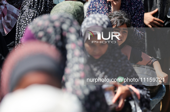 Displaced Palestinians are gathering to receive food at a donation point in Deir al-Balah, central Gaza Strip, on April 19, 2024, amid ongoi...