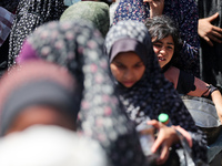 Displaced Palestinians are gathering to receive food at a donation point in Deir al-Balah, central Gaza Strip, on April 19, 2024, amid ongoi...