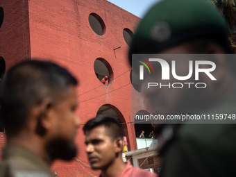 A woman is peering out from a window after a fire broke out in the intensive care unit of the Dhaka Shishu (Children) Hospital in Dhaka, Ban...