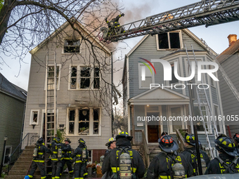 The Chicago Fire Department is battling a significant 2-11 alarm blaze at 2837 North Christiana Avenue in Chicago, Illinois, on April 19, 20...