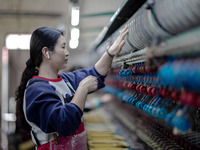 A worker is drawing silk at a mulberry silk processing workshop in Xinghua, China, on April 20, 2024. (