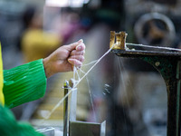 A worker is drawing silk at a mulberry silk processing workshop in Xinghua, China, on April 20, 2024. (