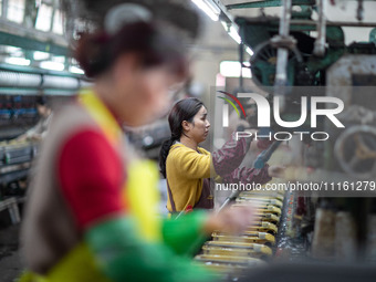 A worker is drawing silk at a mulberry silk processing workshop in Xinghua, China, on April 20, 2024. (