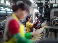 A worker is drawing silk at a mulberry silk processing workshop in Xinghua, China, on April 20, 2024. (