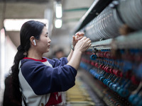 A worker is drawing silk at a mulberry silk processing workshop in Xinghua, China, on April 20, 2024. (