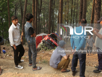 A firefighting engine is crashing in the woods while rushing to douse a forest fire on the outskirts of Kathmandu, Nepal, on April 20, 2024....