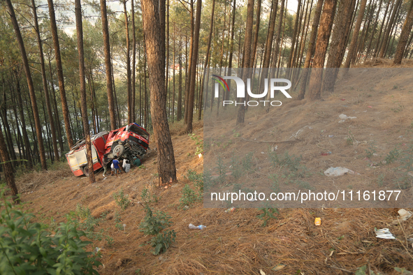 Nepali officials are fixing chains to extract the remains of a firefighting engine that crashed while it was being deployed to douse a fores...