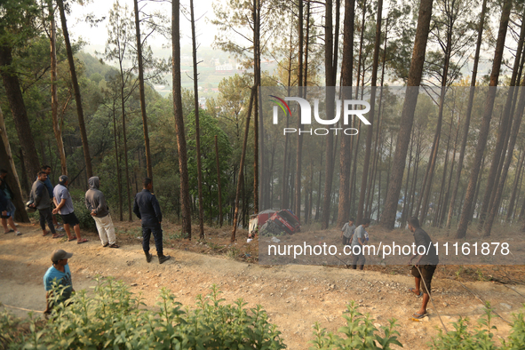 A firefighting engine is crashing in the woods while rushing to douse a forest fire on the outskirts of Kathmandu, Nepal, on April 20, 2024....