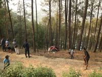 A firefighting engine is crashing in the woods while rushing to douse a forest fire on the outskirts of Kathmandu, Nepal, on April 20, 2024....