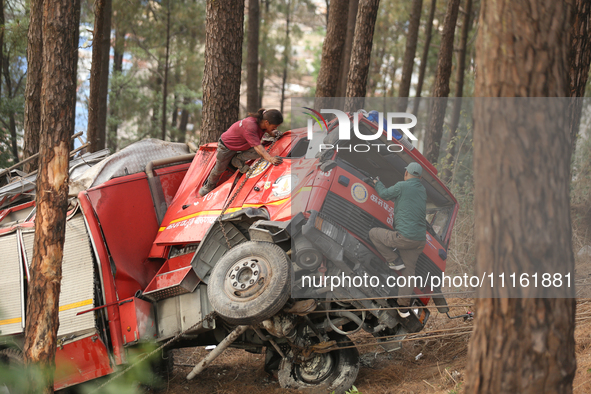 Nepali officials are scouring through the remains of a crashed firefighting engine that crashed while being deployed to douse a forest fire...