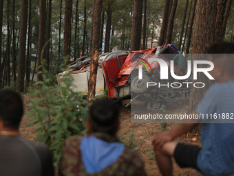 A firefighting engine is crashing in the woods while rushing to douse a forest fire on the outskirts of Kathmandu, Nepal, on April 20, 2024....