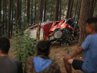 A firefighting engine is crashing in the woods while rushing to douse a forest fire on the outskirts of Kathmandu, Nepal, on April 20, 2024....