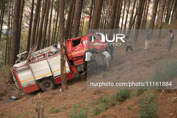 Nepali officials are scouring through the remains of a crashed firefighting engine that crashed while being deployed to douse a forest fire...