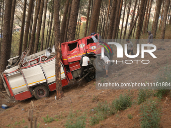 Nepali officials are scouring through the remains of a crashed firefighting engine that crashed while being deployed to douse a forest fire...