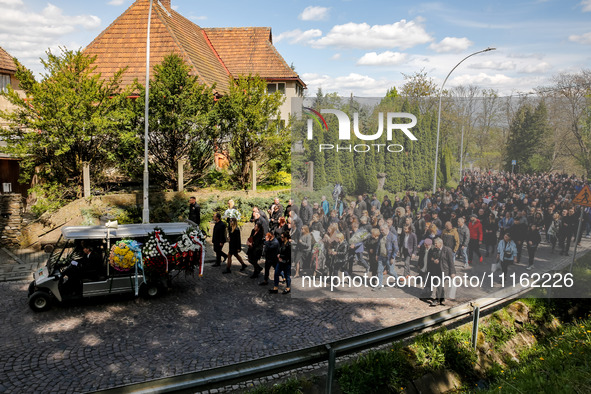 Family and friends walk in a funeral procession as they attend a funeral of Damian Sobol, a volunteer for World Central Kitchen, who was kil...