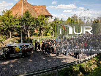 Family and friends walk in a funeral procession as they attend a funeral of Damian Sobol, a volunteer for World Central Kitchen, who was kil...