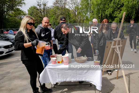 Volunteers of World Central Kitchen give symbolic cup of soup after the funeral of Damian Sobol, a volunteer for World Central Kitchen, who...