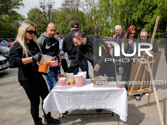 Volunteers of World Central Kitchen give symbolic cup of soup after the funeral of Damian Sobol, a volunteer for World Central Kitchen, who...