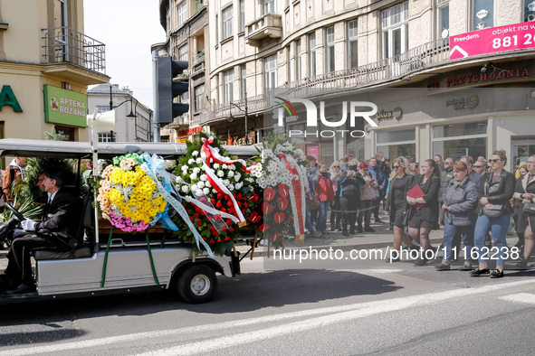 Family and friends walk in a funeral procession as passers by send they respects during funeral of Damian Sobol, a volunteer for World Centr...