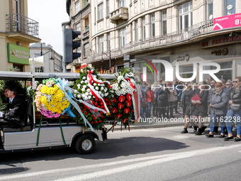 Family and friends walk in a funeral procession as passers by send they respects during funeral of Damian Sobol, a volunteer for World Centr...