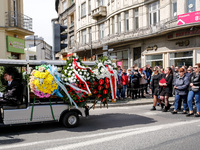 Family and friends walk in a funeral procession as passers by send they respects during funeral of Damian Sobol, a volunteer for World Centr...