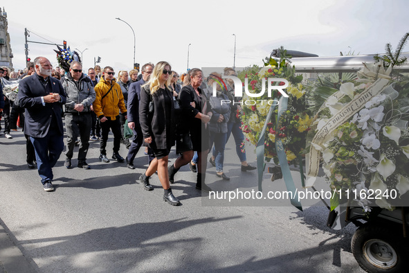 José Andrés, a funder of World Central Kitchen and the family walk in a funeral procession as they attend a funeral of Damian Sobol, a volun...