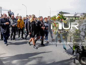 José Andrés, a funder of World Central Kitchen and the family walk in a funeral procession as they attend a funeral of Damian Sobol, a volun...