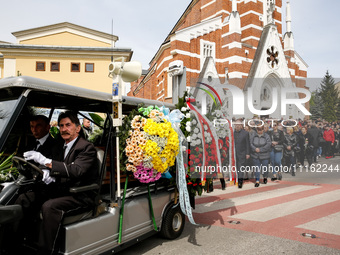 Family and friends walk in a funeral procession as they attend a funeral of Damian Sobol, a volunteer for World Central Kitchen, who was kil...