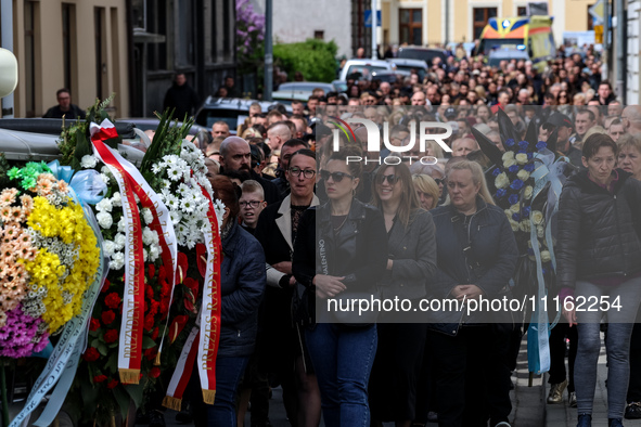 Family and friends walk in a funeral procession as they attend a funeral of Damian Sobol, a volunteer for World Central Kitchen, who was kil...