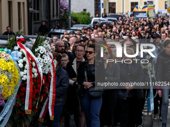 Family and friends walk in a funeral procession as they attend a funeral of Damian Sobol, a volunteer for World Central Kitchen, who was kil...