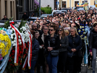 Family and friends walk in a funeral procession as they attend a funeral of Damian Sobol, a volunteer for World Central Kitchen, who was kil...