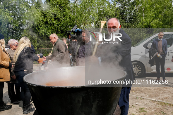 José Andrés, a funder of World Central Kitchen helps to prepare a symbolic soup, usually provided by his organisation, after the funeral of...