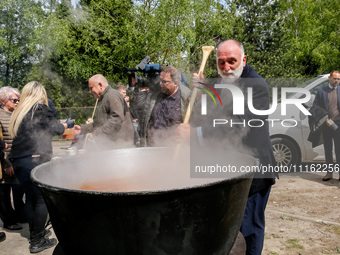 José Andrés, a funder of World Central Kitchen helps to prepare a symbolic soup, usually provided by his organisation, after the funeral of...