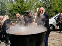 José Andrés, a funder of World Central Kitchen helps to prepare a symbolic soup, usually provided by his organisation, after the funeral of...