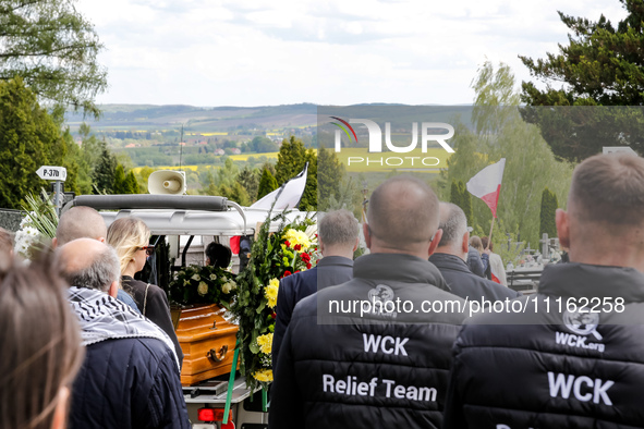 Family and friends walk in a funeral procession as they attend a funeral of Damian Sobol, a volunteer for World Central Kitchen, who was kil...