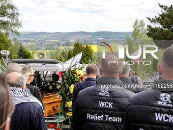 Family and friends walk in a funeral procession as they attend a funeral of Damian Sobol, a volunteer for World Central Kitchen, who was kil...