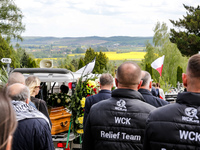 Family and friends walk in a funeral procession as they attend a funeral of Damian Sobol, a volunteer for World Central Kitchen, who was kil...