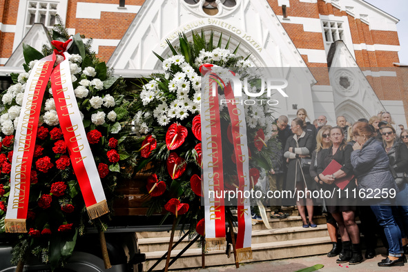 Flowers from President of Poland, Andrzej Duda and Primi Minister of Poland, Donald Tusk are seen as family and friends attend a funeral of...