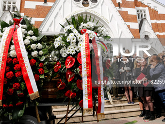 Flowers from President of Poland, Andrzej Duda and Primi Minister of Poland, Donald Tusk are seen as family and friends attend a funeral of...