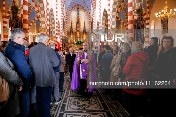 A priest leads a coffin as family and friends attend a funeral of Damian Sobol, a volunteer for World Central Kitchen, who was killed in an...