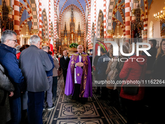 A priest leads a coffin as family and friends attend a funeral of Damian Sobol, a volunteer for World Central Kitchen, who was killed in an...