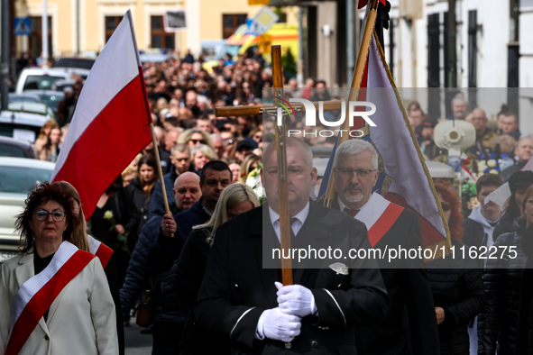 Family and friends walk in a funeral procession as they attend a funeral of Damian Sobol, a volunteer for World Central Kitchen, who was kil...