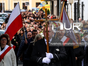 Family and friends walk in a funeral procession as they attend a funeral of Damian Sobol, a volunteer for World Central Kitchen, who was kil...