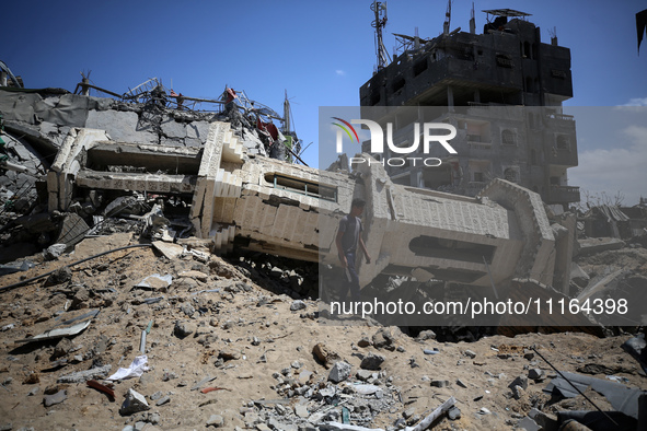 A Palestinian man is walking past a destroyed mosque in Nuseirat, Gaza Strip, on April 21, 2024, amid ongoing battles between Israel and the...