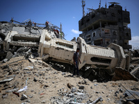 A Palestinian man is walking past a destroyed mosque in Nuseirat, Gaza Strip, on April 21, 2024, amid ongoing battles between Israel and the...