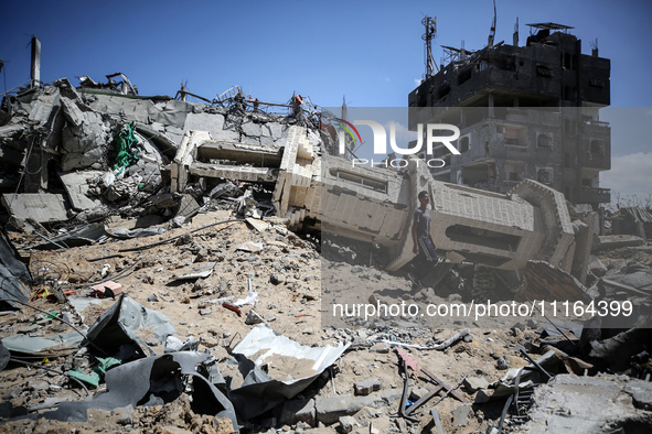 A Palestinian man is walking past a destroyed mosque in Nuseirat, Gaza Strip, on April 21, 2024, amid ongoing battles between Israel and the...