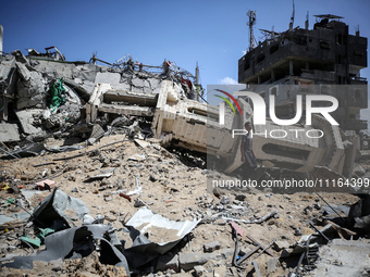 A Palestinian man is walking past a destroyed mosque in Nuseirat, Gaza Strip, on April 21, 2024, amid ongoing battles between Israel and the...